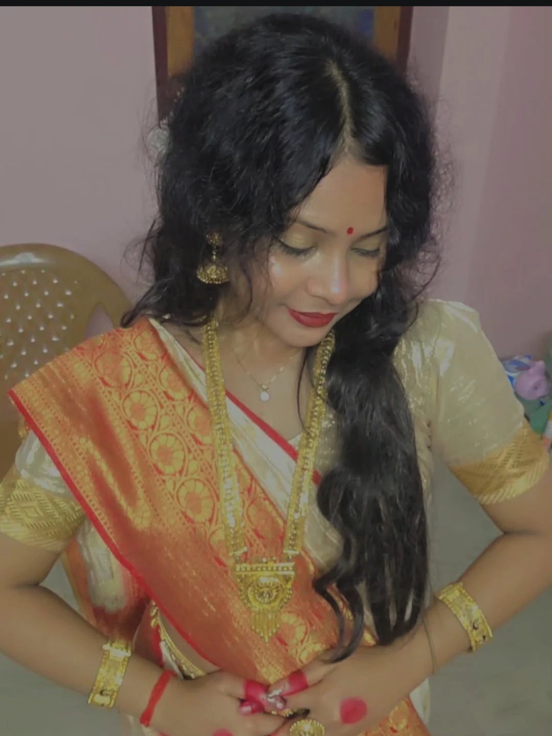 A candid portrait of Swarnali looking down and smiling
